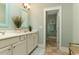 Bright bathroom with double vanity, modern fixtures, and an adjacent shower room at 405 Banyan Place, North Myrtle Beach, SC 29582