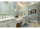 Bathroom featuring double sinks, vanity area, decorative wall art, and walk in shower at 405 Banyan Place, North Myrtle Beach, SC 29582