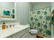 Bathroom featuring a sink, toilet, mirror, and floral shower curtain at 405 Banyan Place, North Myrtle Beach, SC 29582