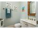 Cozy bathroom with coastal decor, decorative mirror and white vanity at 405 Banyan Place, North Myrtle Beach, SC 29582
