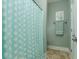 Shower room featuring a turquoise polka dot shower curtain and beach-themed decor at 405 Banyan Place, North Myrtle Beach, SC 29582