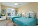 Cozy bedroom with two beds, bright light from shuttered windows, and beachy decor at 405 Banyan Place, North Myrtle Beach, SC 29582