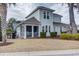 Two story exterior showcasing a screened in porch, manicured bushes, and complementary window placement at 405 Banyan Place, North Myrtle Beach, SC 29582