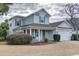 Charming two-story home with a well-manicured lawn, attached two-car garage, and a welcoming front porch at 405 Banyan Place, North Myrtle Beach, SC 29582