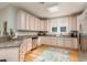 Well lit kitchen with wood flooring, stainless steel appliances, and ample cabinet space at 405 Banyan Place, North Myrtle Beach, SC 29582