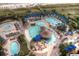 Stunning aerial view of an expansive resort pool area with multiple pools, lounge chairs, and tropical landscaping at 405 Banyan Place, North Myrtle Beach, SC 29582