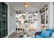 Cozy sunroom featuring white furniture, string lights, and views of the surrounding neighborhood at 405 Banyan Place, North Myrtle Beach, SC 29582