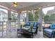 Relaxing sunroom with comfortable wicker furniture and string lights, perfect for outdoor living at 405 Banyan Place, North Myrtle Beach, SC 29582