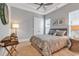 A light-filled bedroom with double windows and a plush queen bed with soft furnishings in a neutral color palette at 410 44Th Ave. N, Myrtle Beach, SC 29577