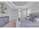 The main bedroom boasts crown moulding, an arched entry way, and soft gray color palette, with lots of natural light at 410 44Th Ave. N, Myrtle Beach, SC 29577