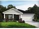 Charming single-story home featuring stone accents, a two-car garage, and a well-maintained lawn at 4307 Falls Oaks St., Myrtle Beach, SC 29579