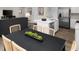 Stylish dining area with sleek black table, views of the modern kitchen and stainless steel refrigerator at 434 Myrtle Meadows Dr, Conway, SC 29526