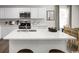 Bright modern kitchen with white cabinets, island, stainless appliances, and hardwood floors at 434 Myrtle Meadows Dr, Conway, SC 29526