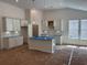 Bright, spacious kitchen featuring white cabinetry, an island and abundant natural light at 444 Sun Colony Blvd., Longs, SC 29568