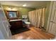 A bathroom with a vanity, toilet and shower with patterned curtain and hardwood floors at 4633 Lightkeepers Way # 5K, Little River, SC 29566