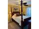 This bedroom has a four-poster bed, ceiling fan and a sliding door at 4633 Lightkeepers Way # 5K, Little River, SC 29566