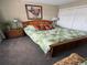 Comfortable bedroom featuring a wooden bed frame, a large window, and leafy green patterned bedding at 4633 Lightkeepers Way # 5K, Little River, SC 29566