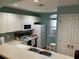 Modern kitchen with sleek white cabinets and a convenient breakfast bar at 4633 Lightkeepers Way # 5K, Little River, SC 29566