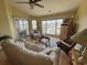 Inviting living room featuring a ceiling fan, comfortable seating, and marina views at 4633 Lightkeepers Way # 5K, Little River, SC 29566