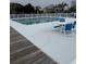 Community pool with white fence, table and chairs nearby at 4633 Lightkeepers Way # 5K, Little River, SC 29566
