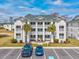 Beautiful three-story condo with private balconies, palm trees, and parking at 473 White River Dr. # C, Myrtle Beach, SC 29579