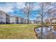 Exterior shot of the condo buildings with a pond in the background at 473 White River Dr. # C, Myrtle Beach, SC 29579