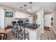 Kitchen area boasts a dark granite countertop, bar stool seating, white cabinets, and modern lighting fixtures at 473 White River Dr. # C, Myrtle Beach, SC 29579