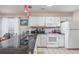 Charming kitchen featuring white cabinets, sleek granite counter tops, and modern appliances, bathed in natural light at 473 White River Dr. # C, Myrtle Beach, SC 29579