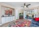 Inviting living room with built-in cabinet, ceiling fan, colorful rug, sliding glass door, and a view to the outdoor patio at 473 White River Dr. # C, Myrtle Beach, SC 29579