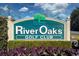 River Oaks Golf Club sign surrounded by manicured landscaping at 473 White River Dr. # C, Myrtle Beach, SC 29579