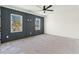 Room with modern dark blue wall panelling, ceiling fan, and lots of natural light at 481 Starlit Way, Myrtle Beach, SC 29579