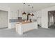 Modern kitchen with white cabinets, pendant lighting, and a large center island at 481 Starlit Way, Myrtle Beach, SC 29579
