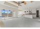 Open-concept living room with lake views, tray ceiling, and seamless access to the kitchen at 481 Starlit Way, Myrtle Beach, SC 29579