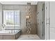 Modern bathroom featuring a glass-enclosed shower, soaking tub, and stylish tile accents, creating a spa-like experience at 5220 Mount Pleasant Dr., Myrtle Beach, SC 29579