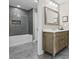 Bathroom with a modern vanity, marble countertop, decorative mirror and a tiled shower at 5220 Mount Pleasant Dr., Myrtle Beach, SC 29579
