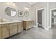 Elegant Primary bathroom featuring dual vanities, round mirrors, and a separate water closet for added privacy at 5220 Mount Pleasant Dr., Myrtle Beach, SC 29579