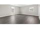 A bright bedroom with two windows and stylish flooring at 5220 Mount Pleasant Dr., Myrtle Beach, SC 29579