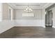 Elegant dining room featuring modern chandelier, framed mirror, and paneled walls at 5220 Mount Pleasant Dr., Myrtle Beach, SC 29579