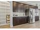 Open-concept kitchen with stainless steel appliances, dark wood cabinets, a large pantry and wood floors at 5220 Mount Pleasant Dr., Myrtle Beach, SC 29579