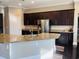 Kitchen featuring dark wood cabinets, granite countertops, and stainless steel refrigerator at 5220 Mount Pleasant Dr., Myrtle Beach, SC 29579