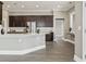 Modern kitchen features dark wood cabinets, stainless steel appliances, and a large island with white countertop at 5220 Mount Pleasant Dr., Myrtle Beach, SC 29579