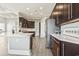 Open kitchen with quartz countertops, dark wood cabinets, stainless appliances and views to the outdoors at 5220 Mount Pleasant Dr., Myrtle Beach, SC 29579
