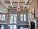 Sun-filled living room featuring a fireplace, coffered ceiling and many windows at 5220 Mount Pleasant Dr., Myrtle Beach, SC 29579