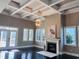 Bright living room with coffered ceiling, fireplace, dark floors and ample natural light at 5220 Mount Pleasant Dr., Myrtle Beach, SC 29579