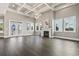Spacious living room with a coffered ceiling, a modern chandelier, a fireplace, and lots of natural light at 5220 Mount Pleasant Dr., Myrtle Beach, SC 29579