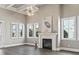 Bright living room featuring a fireplace, large windows, wood floors and stylish decor at 5220 Mount Pleasant Dr., Myrtle Beach, SC 29579