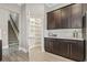 Kitchen with spacious walk-in pantry, dark wood cabinets, and stainless steel appliances at 5220 Mount Pleasant Dr., Myrtle Beach, SC 29579