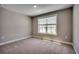 Comfortable bedroom with neutral-colored walls, carpet, and a large window overlooking a lake at 5430 Shelly Lynn Dr., Myrtle Beach, SC 29579
