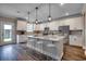 Modern kitchen featuring stainless steel appliances, an island with barstool seating, and hardwood floors at 5430 Shelly Lynn Dr., Myrtle Beach, SC 29579