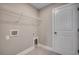 Clean laundry room with a white door, utility connections, and a wire shelf for storage at 5430 Shelly Lynn Dr., Myrtle Beach, SC 29579